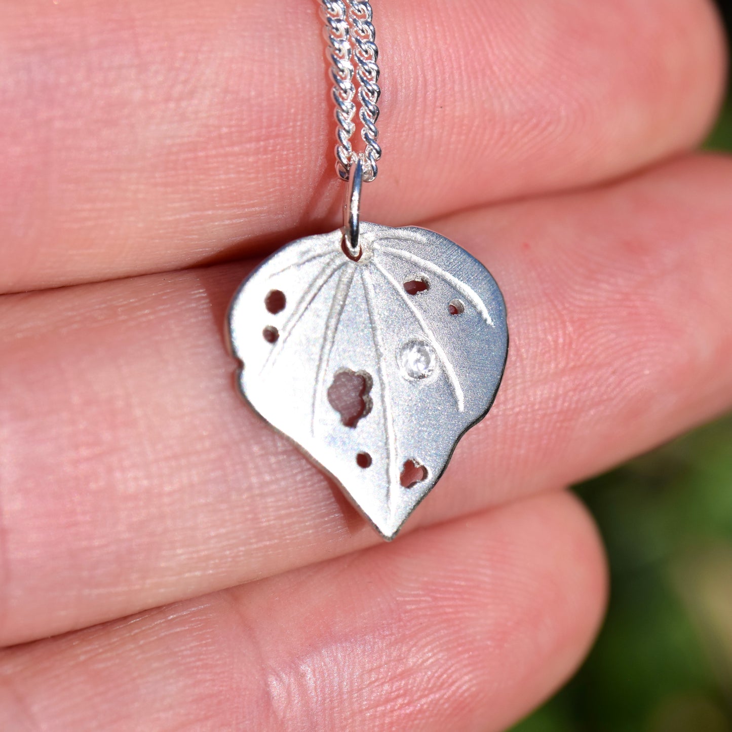 Sterling silver kawakawa pendant with tiny cubic zirconia