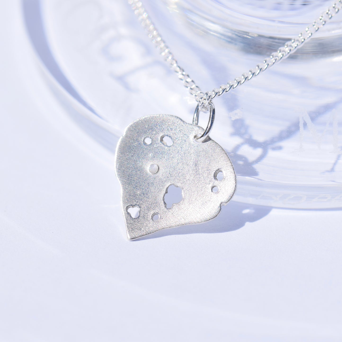 Sterling silver kawakawa pendant with tiny cubic zirconia